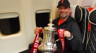 Liverpool manager Jurgen Klopp holding the FA Cup, 2022