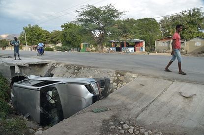 A car that was hit by a bus early Sunday in Haiti.