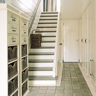 hallway with cream coloured and stair with drawers