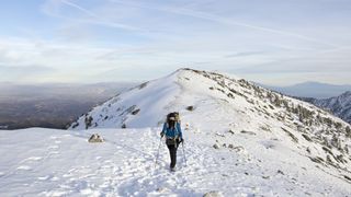 Hiker on the summit of Mount Baldy in winter
