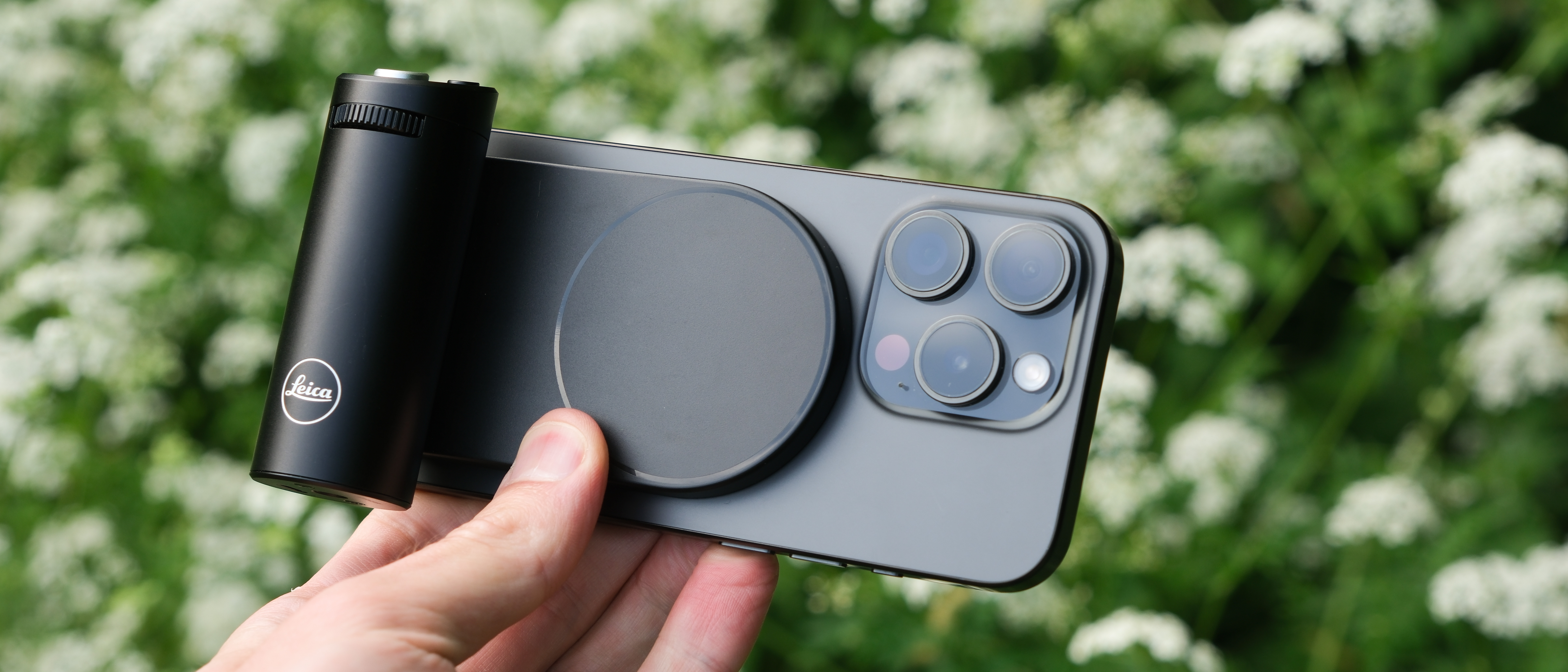 Leica Lux Grip attached to an iPhone and held in a hand