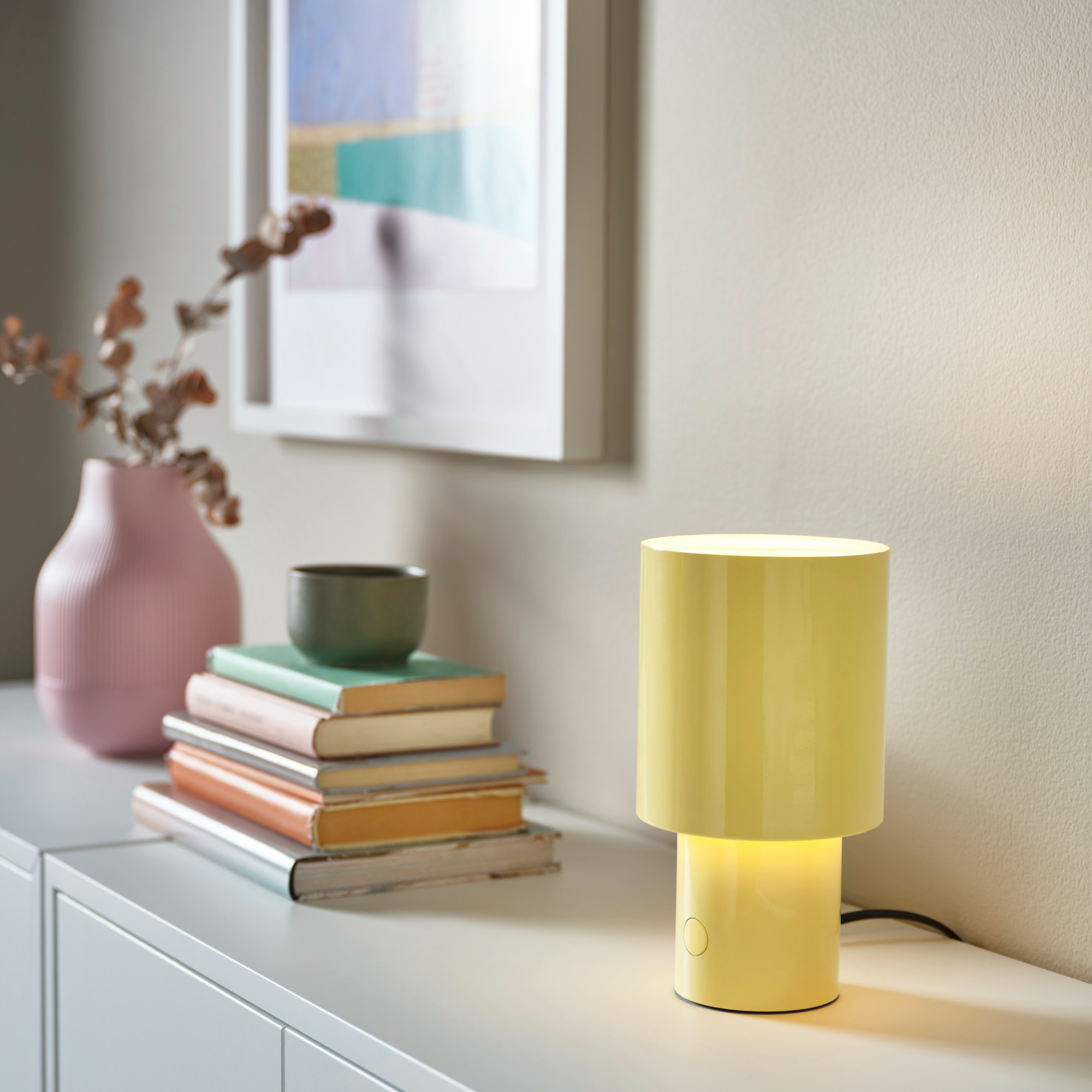 IKEA SPETSBOJ lamp in yellow on a white sideboard with a pink vase