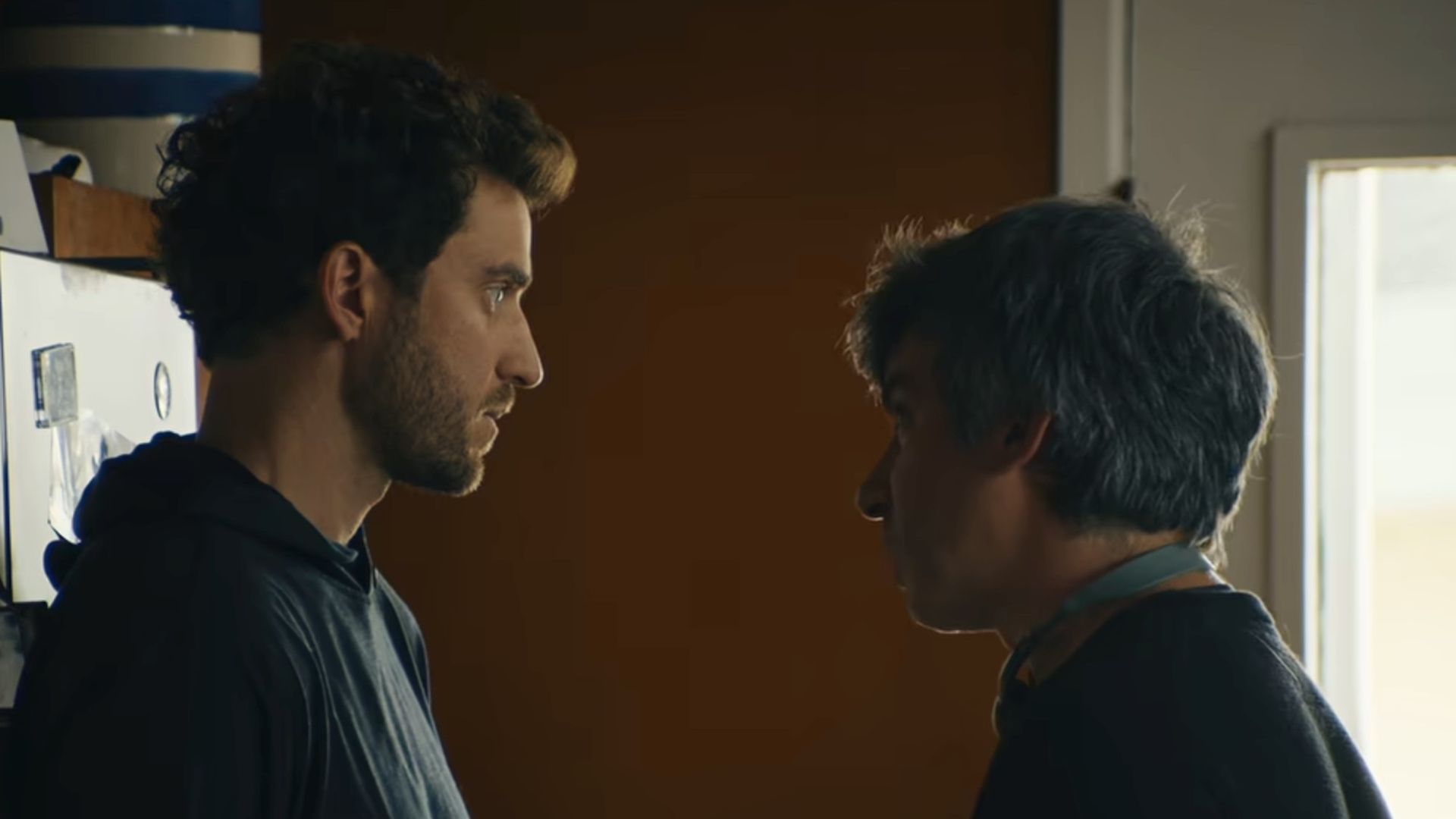 Billy Evans on the left, talking to Nathan Fielder in the kitchen in You Can See Everything.