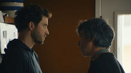 Billy Evans on the left, talking to Nathan Fielder in the kitchen in You Can See Everything. 