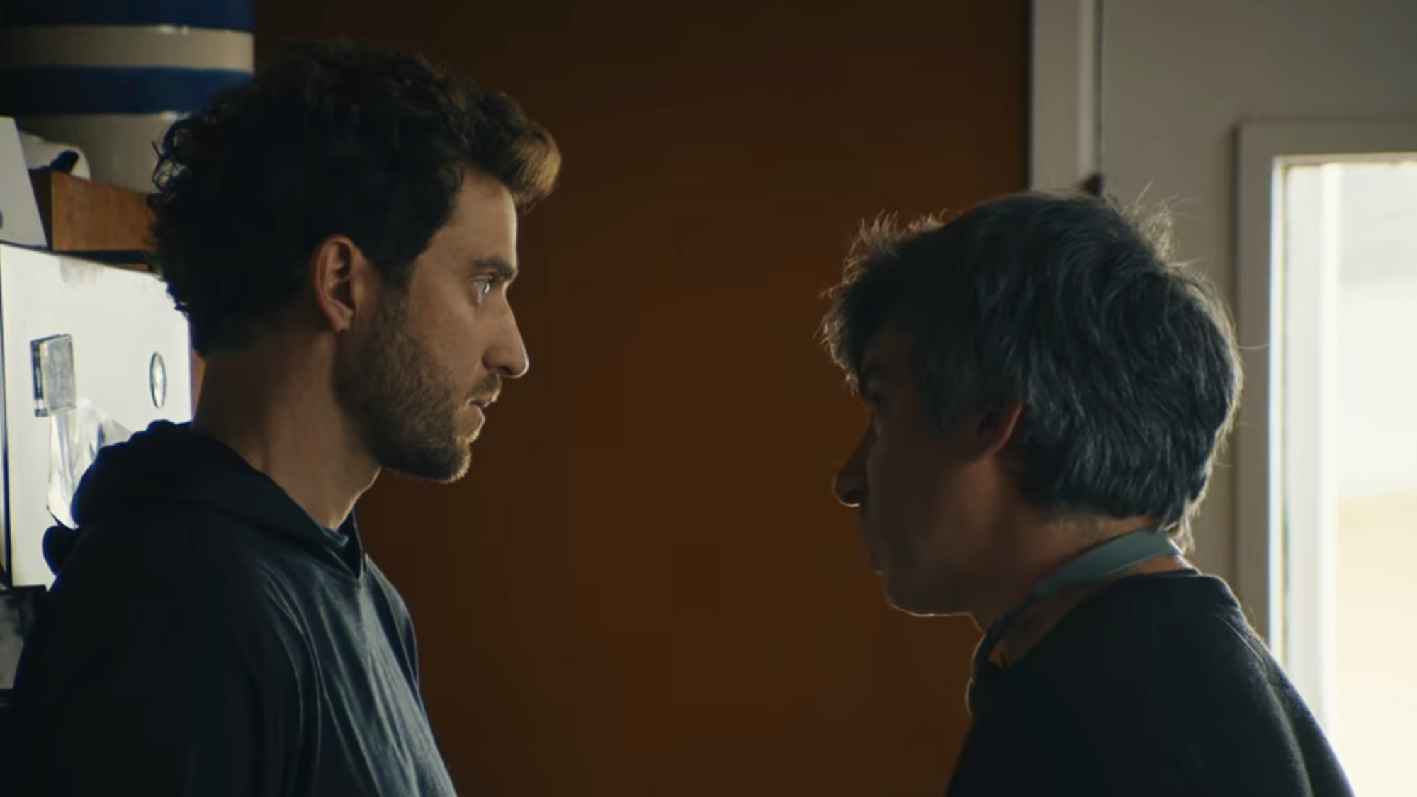 Billy Evans on the left, talking to Nathan Fielder in the kitchen in You Can See Everything.