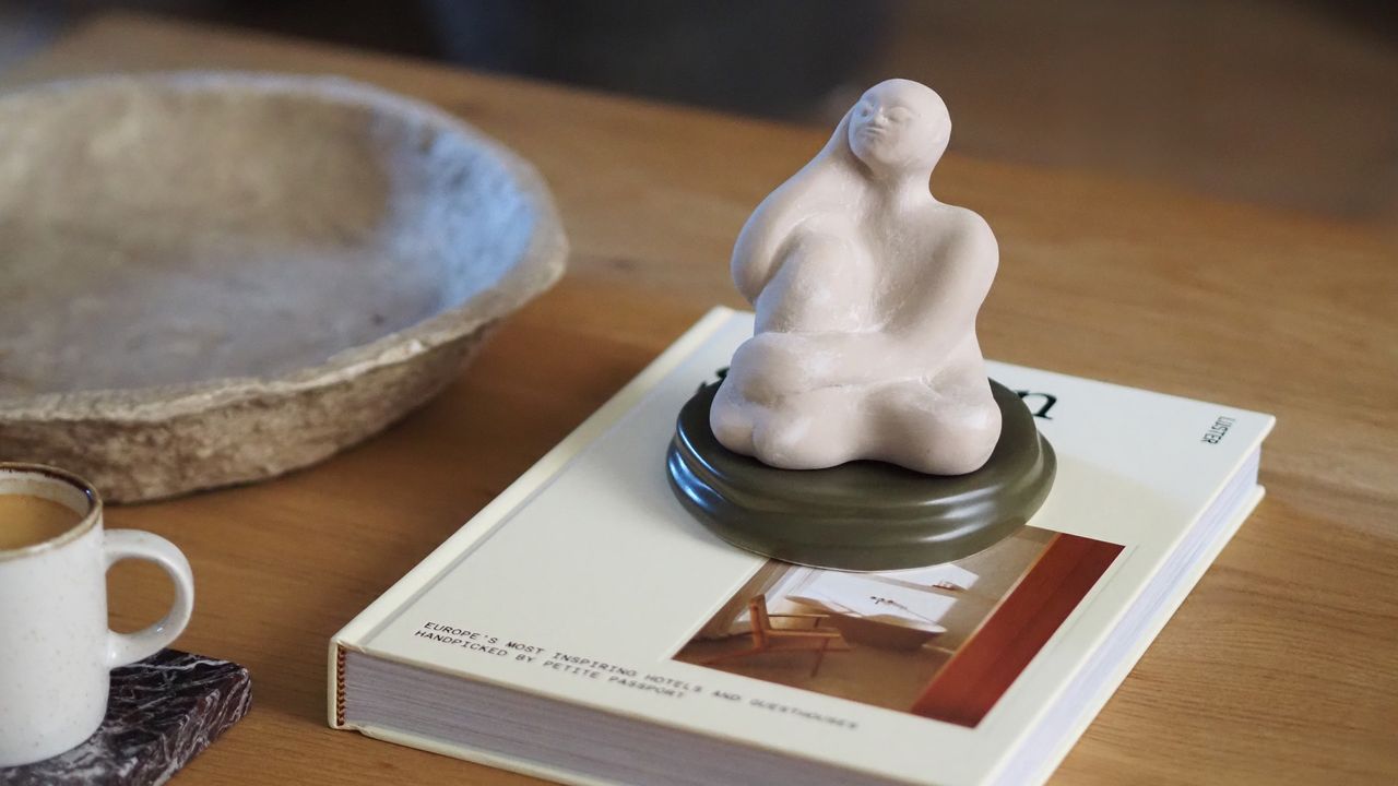a scented statue on a coffee table on top of a book