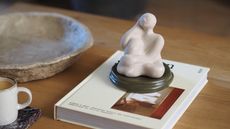 a scented statue on a coffee table on top of a book