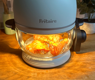 Fritaire Self-Cleaning Air Fryer cooking chicken thighs