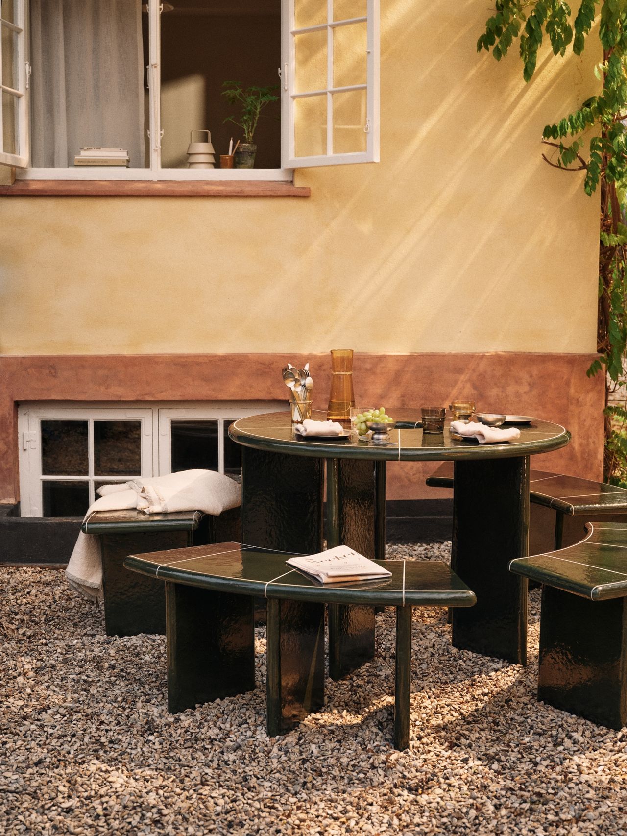 an outdoor round table with matching round benches