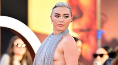 Florence Pugh wearing a silver pleated backless gown