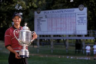 Tiger Woods holds the Wanamaker Trophy in 1999