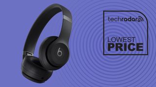 Beats Solo 4 in black on purple background with lowest price TechRadar sign