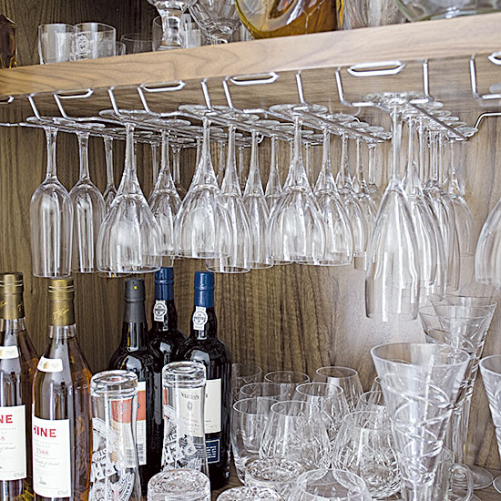 cupboard with drinks storage and glasses with bottles