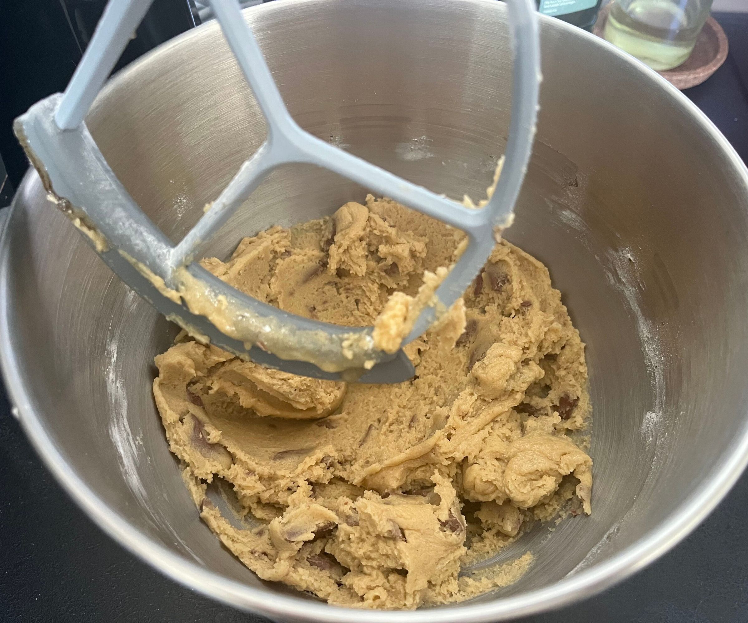 Mixed cookie dough in the stainless steel bowl of the SMEG Forte Stand Mixer fitted with a flex edge paddle. 