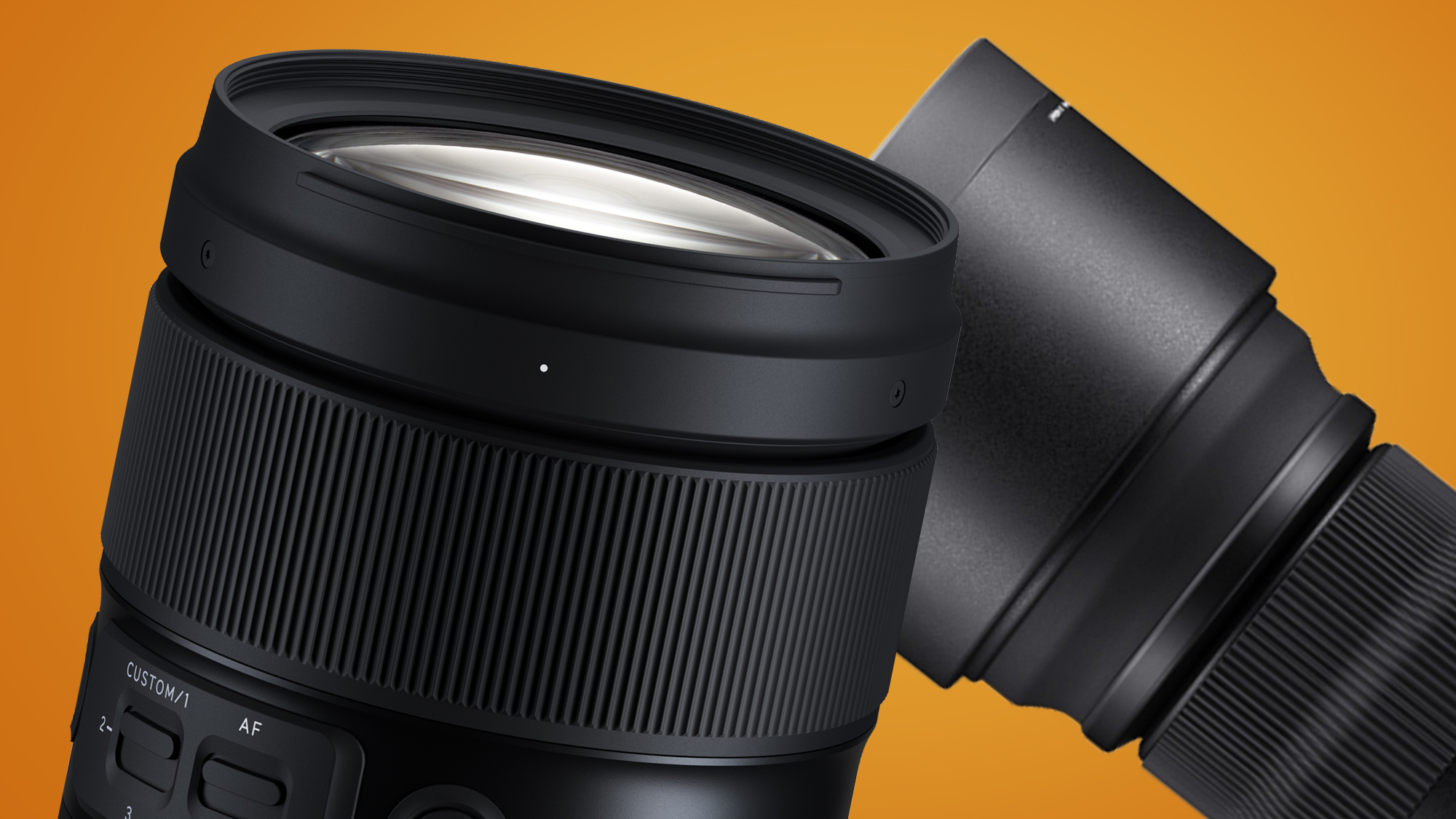 The Tamron 35-150mm f/2-2.8 in front of a Sigma lens on an orange background