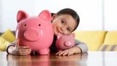 Girl with two pink piggy banks
