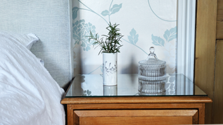 Rosemary in vase on bedside table