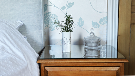 Rosemary in vase on bedside table
