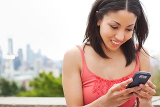 girl sending a text message on her cellphone
