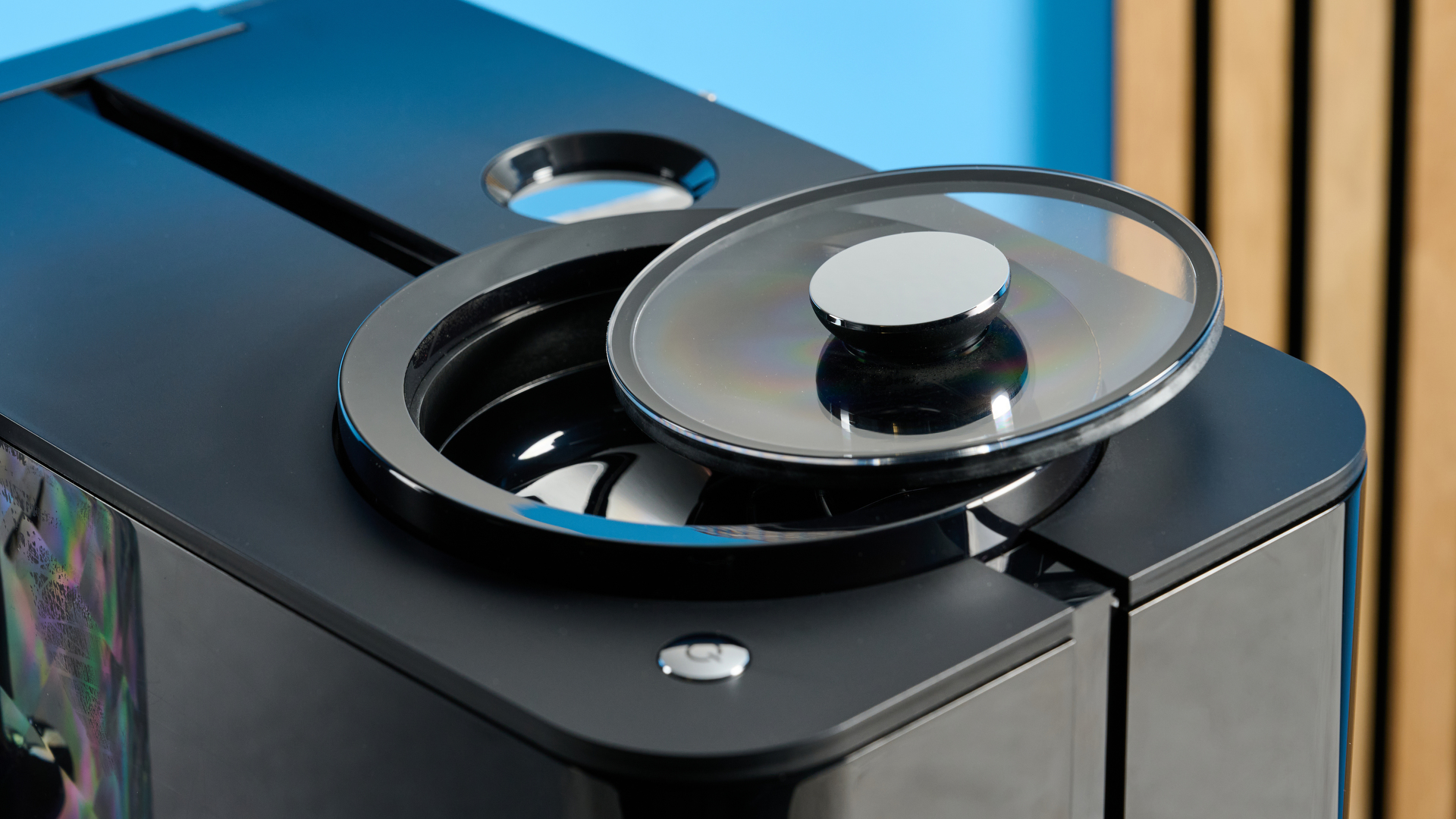 the jura ena 4 automatic coffee machine in piano black with a faceted water tank and bright screen