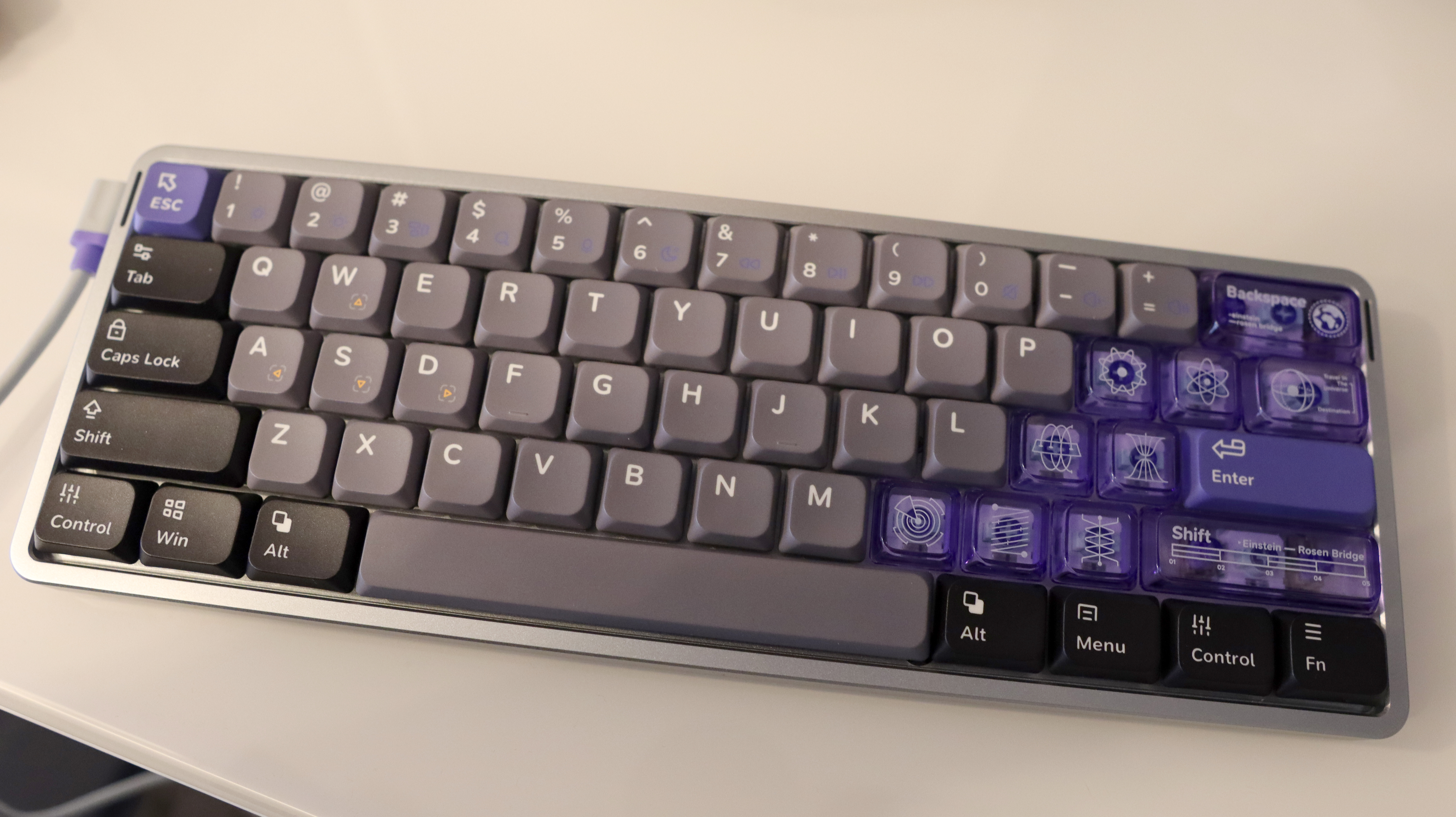 NuPhy Air60 HE gaming keyboard on a desk with RGB enabled.