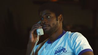 Quincy Isaiah as Magic Johnson on the phone in Winning Time season 2 episode 3
