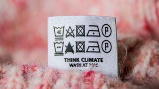 Laundry care symbol on a pink sweater.