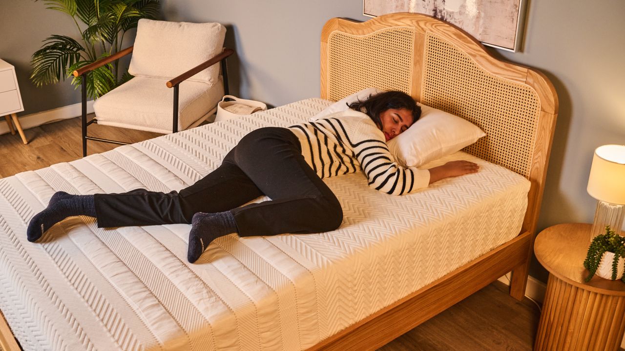 Our tester sleeps on her front while testing the Leesa Legend Hybrid Mattress