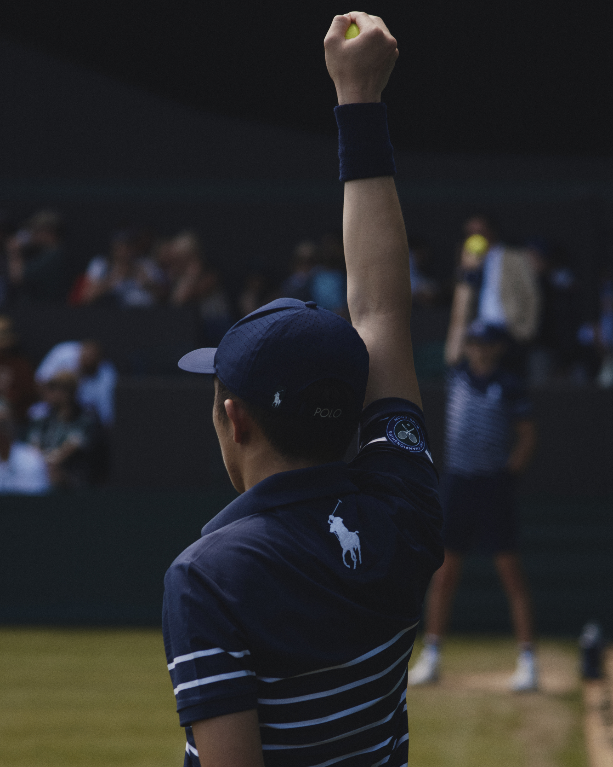 Wimbledon ball boy holds ball aloft
