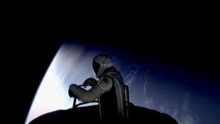 A spaceman pops out of a spacecraft above earth