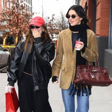 Kendall Jenner wears a suede blazer, straight leg jeans and loafers.