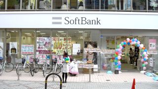 A girl stands outside a SoftBank branch in Hankyu-Ibaraki, Japan