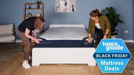Testers inspect the newly unboxed DreamCloud Classic mattress, with a Tom's Guide Black Friday Mattress Deals badge overlaid