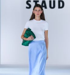 A model wearing a slip skirt on Staud's Spring '24 runway.