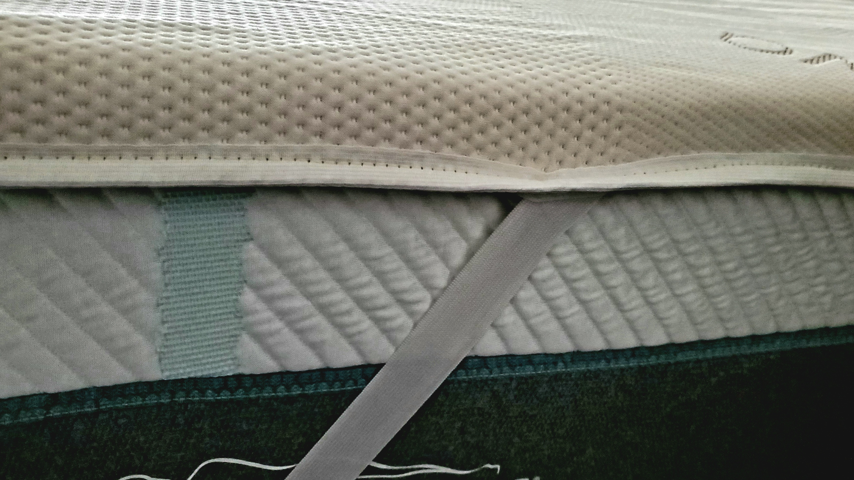 Saatva foam mattress topper with fixing straps