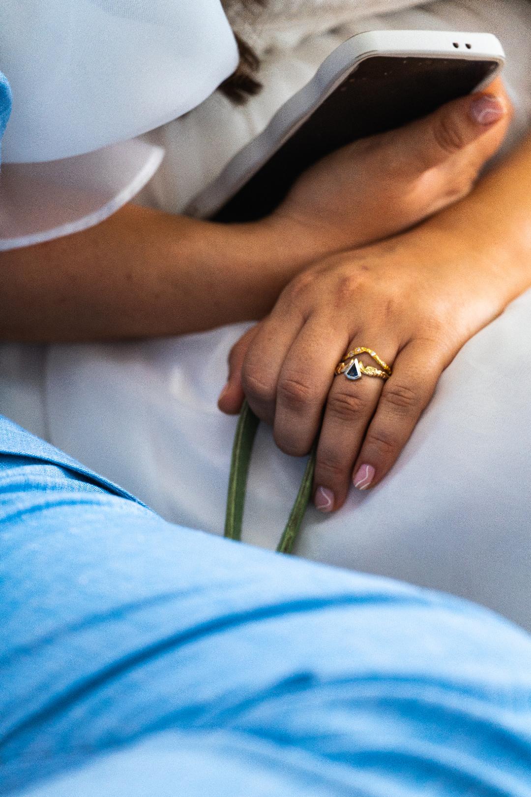 a close up of stephanie sophokleous's engagement ring and wedding band stack