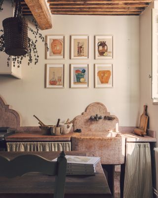 A Provençal-style house features wooden ceilings, rock basins, and contemporary wall art on the walls.