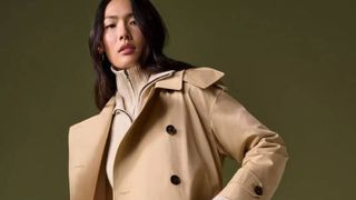 Woman in M&S beige coat looking at the camera