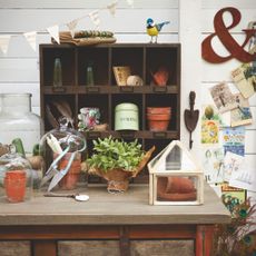 Potting shed with a potting bench covered in garden accessories