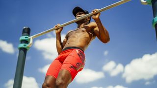 Young athletic man doing pull ups