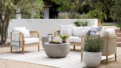 A wood and wicker outdoor lounge set in a contemporary backyard