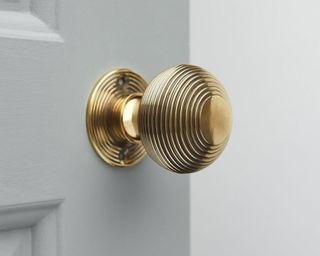brass door knob on door - grace and glory home