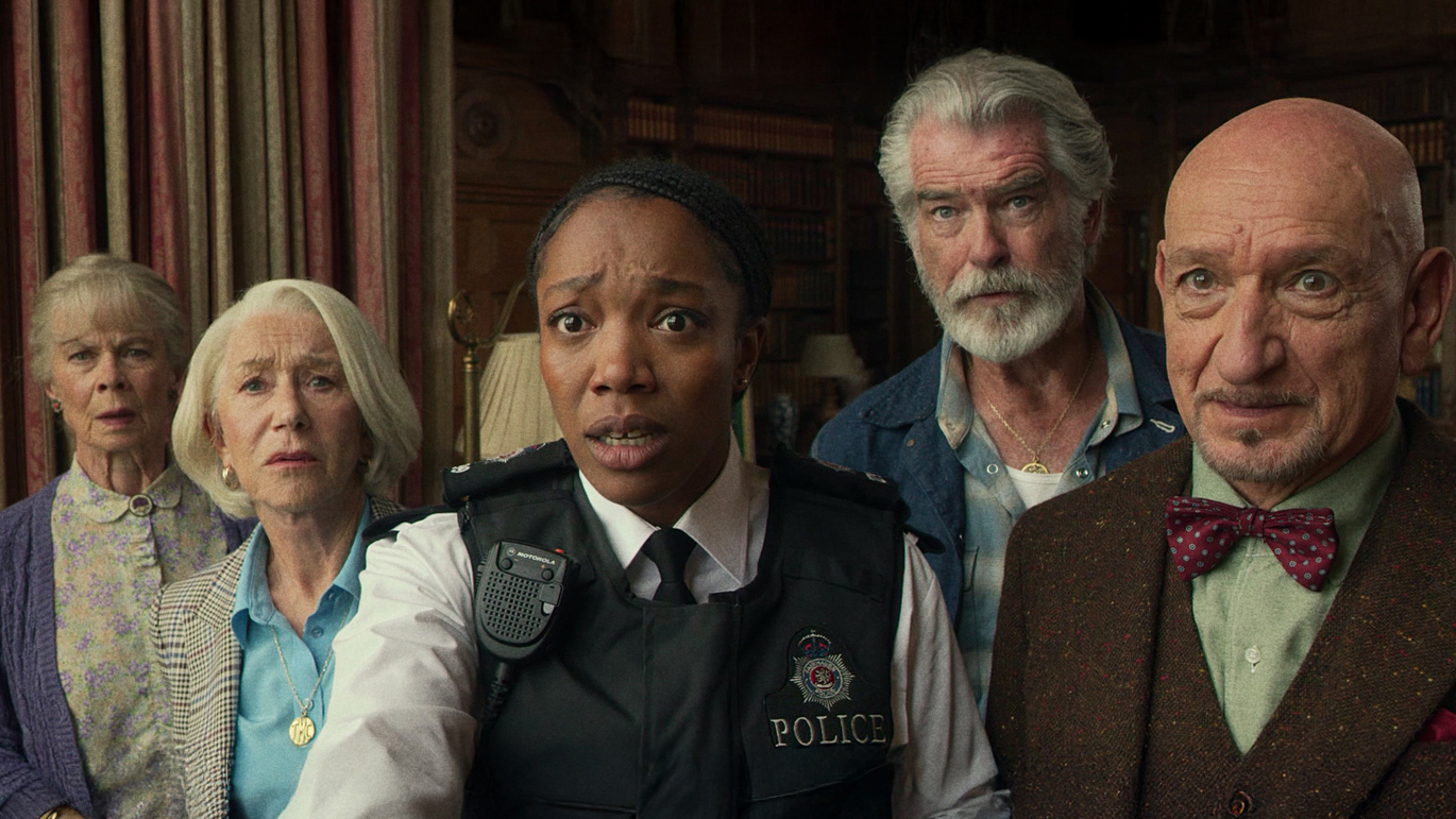 L-R: Celia Imrie, Helen Mirren, Naomi Ackie, Pierce Brosnan, Ben Kingsley stand together in a scene from Netflix's "The Thursday Murder Club" movie
