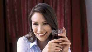 model eating steak cheese chocolate wine and bread at restaurant