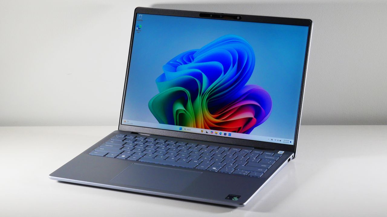 Dell Inspiron 14 Plus 7441 (Snapdragon X Plus) open at an angle showing the display on a white table.