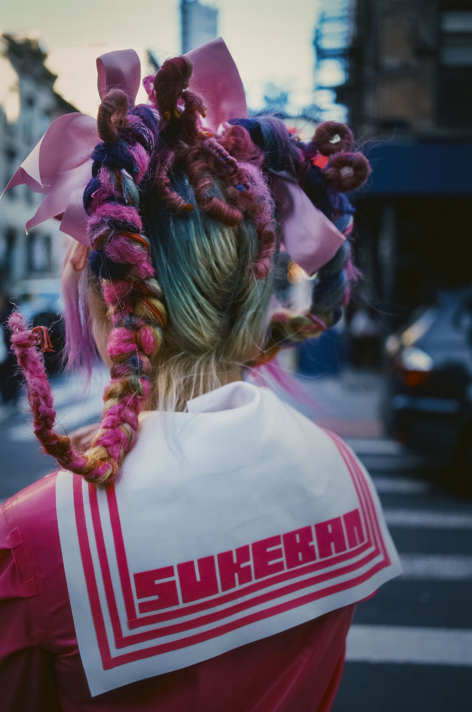 Female wrestler from behind, with pink dressing in hair