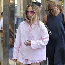 Jennifer Lopez in Istanbul wearing a pink matching set with gold flip flops.