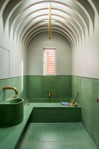 green and grey bathroom with curved vaulted ceiling