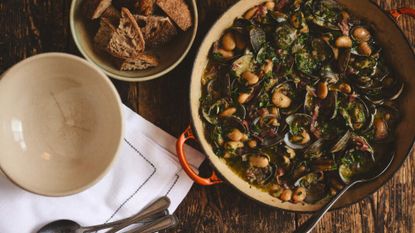clams, butter beans and jamon in a pot