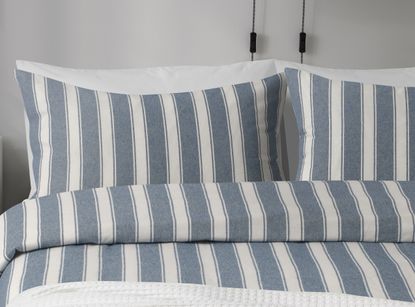 A close up of blue and white striped pillows